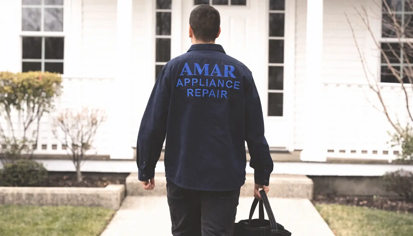 Amar Appliance Repair technician arriving at a customer's front door with a tool bag